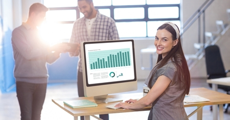 Digital composite of Businesswoman working on graph while colleagues communicating in office