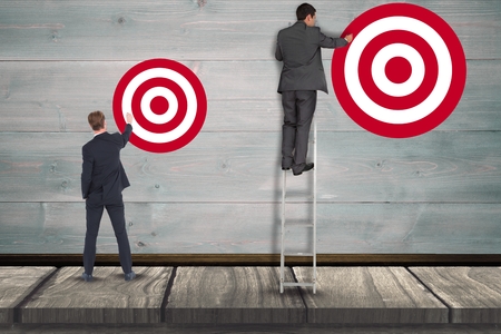 Digital composite of Digital composite image of businessman setting targets on wallの写真素材