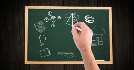 Digital composite of Cropped hand of man drawing on blackboard at wooden tableの写真素材