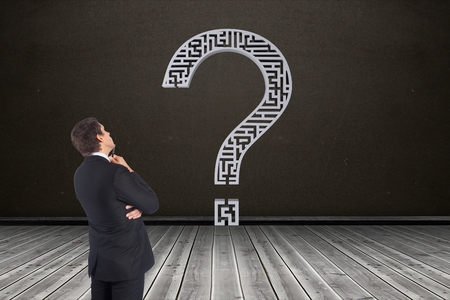 Digital composite of Businessman looking at question markの写真素材