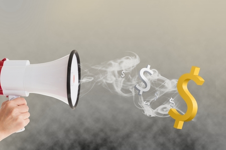 Digital composite of Hand holding megaphone with dollar signs and smoke coming outの写真素材