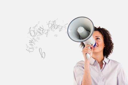 Digital composite of Young businesswoman talking in megaphoneの写真素材
