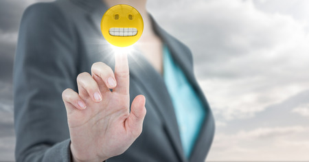 Digital composite of Business woman mid section with flare against cloudy skyの写真素材