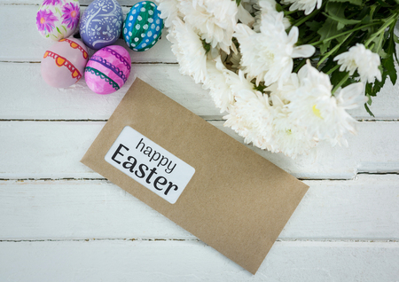 Digital composite of Eggs, flowers and envelope with grey type on table