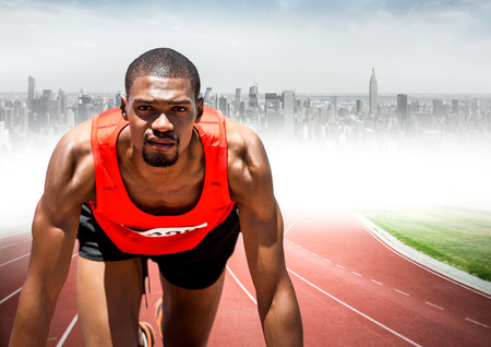 Digital composite of Male runner on track against blurry skyline