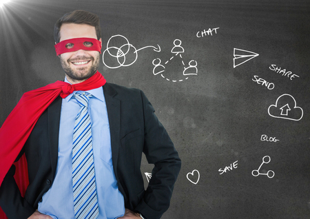 Digital composite of Business man superhero with hands on hips against grey wall with white business doodles and flareの写真素材