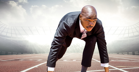 Digital composite of Business man at start line on track against flaresの写真素材