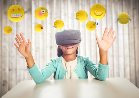 Digital composite of Kid in VR beneath emojis against blurry wood panel