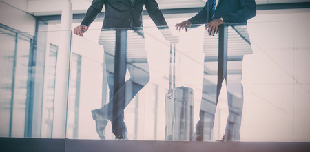 Businessman talking with colleague in officeの写真素材