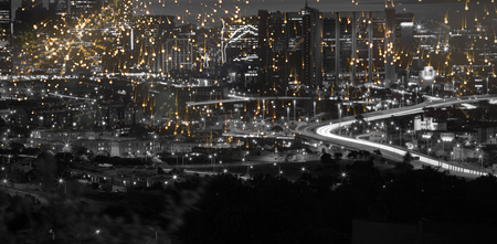 Colourful fireworks exploding on black background against high angle view of illuminated cityscape