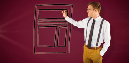 Geeky businessman writing with marker against pink backgroundの写真素材
