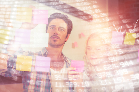 Stocks and shares against business people planning with sticky notes on glass