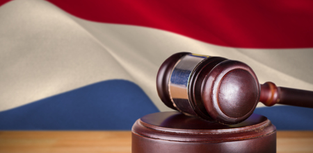 Hammer and gavel against 3d digitally generated dutch national flagの写真素材