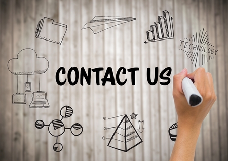 Digital composite of Hand with marker against contact doodles and blurry wood panelの写真素材