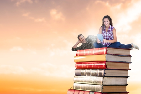 Digital composite of Composite image of couple on booksの写真素材