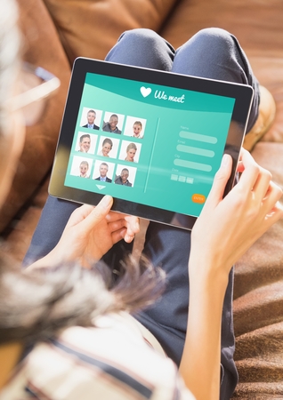 Digital composite of Woman on a sofa with tablet in login screenの写真素材