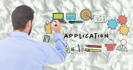 Digital composite of Back of business man with marker against application doodles and paperの写真素材