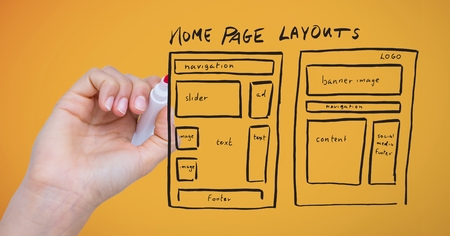 Digital composite of Hand with marker and website mock up against yellow background