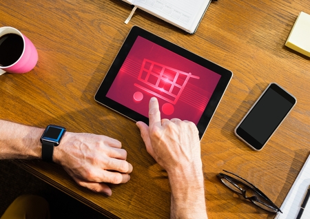 Digital composite of Person using Tablet with Shopping trolley iconの写真素材