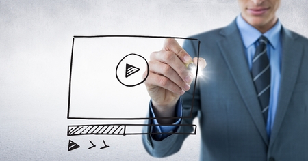 Digital composite of Business man mid section with marker and website mock up with flare against white wallの写真素材