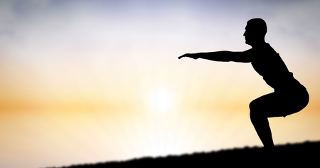 Digital composite of Silhouette of man exercising against sky during sunsetの写真素材