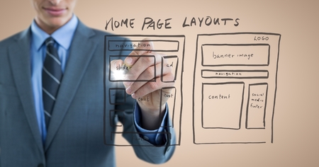 Digital composite of Business man mid section with marker and website mock up with flare against...