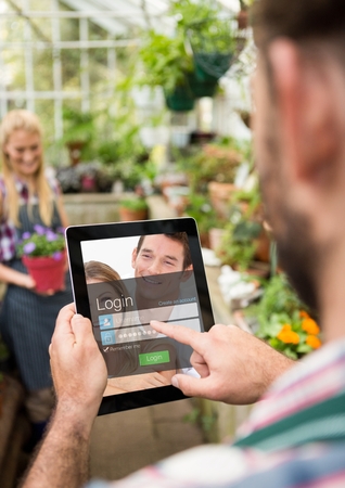 Digital composite of Men with tablet in a garden. Login screenの写真素材