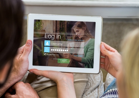 Digital composite of Couple with tablet in login screenの写真素材