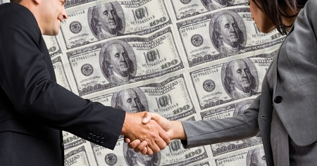 Digital composite of Business people shaking hands with dollars in backgroundの写真素材