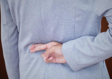 Digital composite of Woman fingers crossedの写真素材