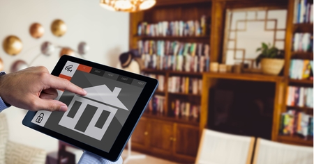 Digital composite of Hand using smart home application on digital tabletの写真素材