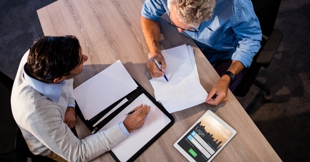 Digital composite of Business people discussing by signup screen on tablet PCの写真素材