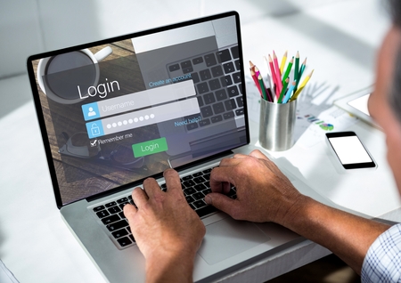 Digital composite of Men with laptop on the desk. Screen with loginの写真素材