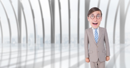 Digital composite of Happy nerd businessman standing in officeの写真素材