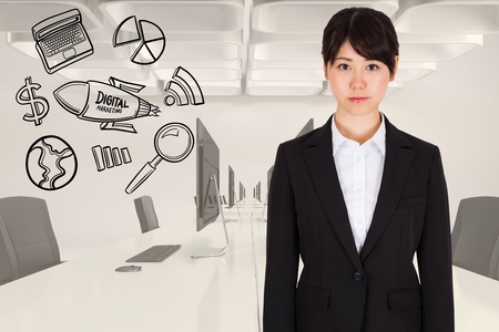 Digital composite of Digitally generated image of businesswoman standing by various icons in officeの写真素材