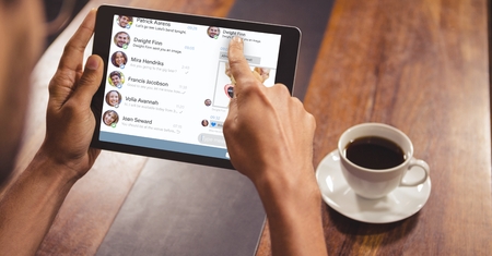 Digital composite of Cropped image of hand using digital tablet with chat list