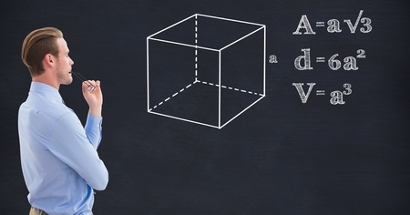 Digital composite of Businessman looking at structure and various formulas on blackboardの写真素材