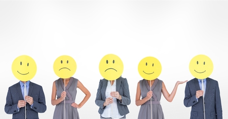 Digital composite of Business people covering faces with various smileys against white backgroundの写真素材