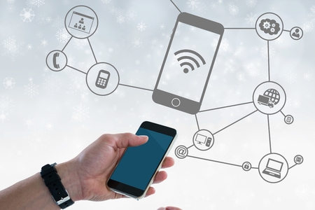 Digital composite of Digital composite image of hand holding smart phone with connection graphics in...