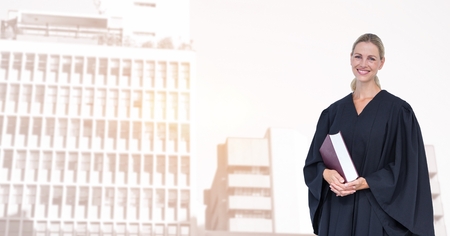 Digital composite of Portrait of smiling judge holding book in cityの写真素材