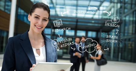 Digital composite of Digital composite image of confident businessman holding tablet PC by text and iconsの写真素材