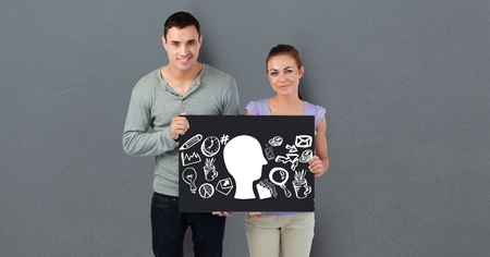 Digital composite of Portrait of couple holding billboard with various iconsの写真素材