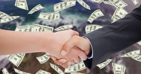 Digital composite of Close-up of business people shaking hands with money in backgroundの写真素材