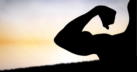Digital composite of Silhouette muscular man flexing muscles against skyの写真素材