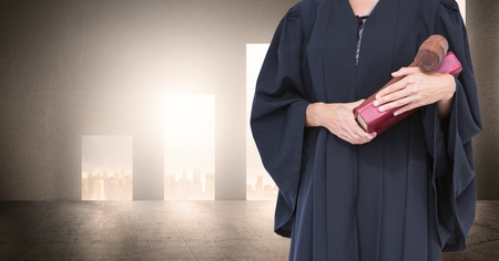Digital composite of Midsection of judge with book and gavelの写真素材