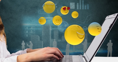 Digital composite of Digital composite image of businesswoman using laptop while emojis flying over itの写真素材