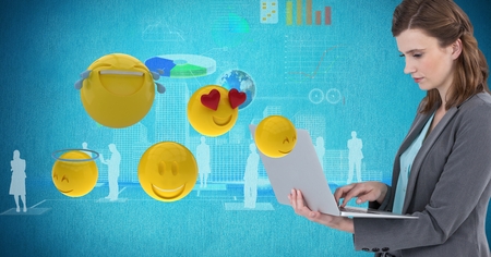 Digital composite of Digital composite image of businesswoman using laptop by various emojisの写真素材