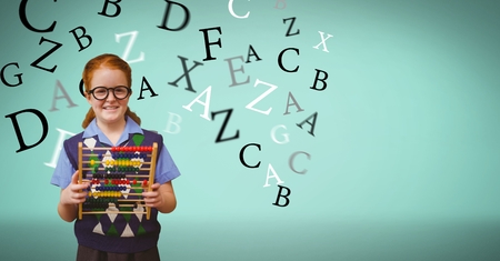 Digital composite of Smiling schoolgirl holding abacus  while letters flying in backgroundの写真素材
