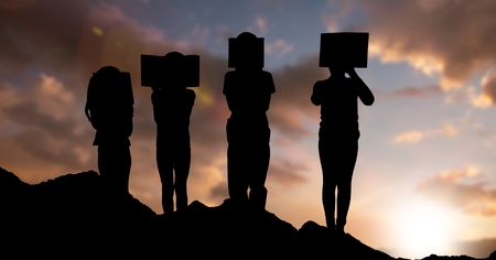 Digital composite of Silhouette children with books against sky during sunsetの写真素材