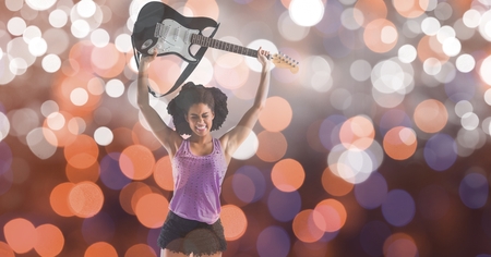 Digital composite of Music artist holding guitar over bokehの写真素材